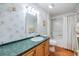 Single vanity, shower/tub combo, and floral wallpaper at 37538 New Horizons Blvd, Zephyrhills, FL 33541