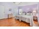 Lavender walls, wood floors, and twin beds at 37538 New Horizons Blvd, Zephyrhills, FL 33541