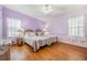 Light purple walls, wood floors, and twin beds at 37538 New Horizons Blvd, Zephyrhills, FL 33541
