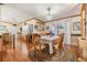 Bright dining area with a wooden table and chairs, and a view of the living room at 37538 New Horizons Blvd, Zephyrhills, FL 33541