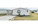Well-maintained manufactured home with landscaped yard and covered carport at 37538 New Horizons Blvd, Zephyrhills, FL 33541