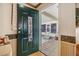 Green front door with decorative wall hanging leading to the front porch at 37538 New Horizons Blvd, Zephyrhills, FL 33541