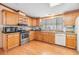 Well-equipped kitchen featuring wood cabinets and stainless steel appliances at 37538 New Horizons Blvd, Zephyrhills, FL 33541