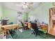 Home office with wood desk and two chairs at 37538 New Horizons Blvd, Zephyrhills, FL 33541
