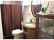 Bathroom with vanity, toilet, shower, and decorative cabinet at 3915 W Paxton Ave, Tampa, FL 33611