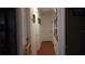 Long hallway with light wood floors and access to multiple rooms at 3915 W Paxton Ave, Tampa, FL 33611