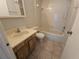 Bathroom with shower/tub combo and wood vanity at 4031 Tumble Wood Trl # 203, Tampa, FL 33613