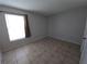 Bedroom with tile floors and large window at 4031 Tumble Wood Trl # 203, Tampa, FL 33613