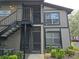Exterior view of condo building with stairs and landscaping at 4031 Tumble Wood Trl # 203, Tampa, FL 33613
