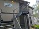 Exterior view of condo building with stairs and address number 4031 at 4031 Tumble Wood Trl # 203, Tampa, FL 33613