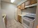 Kitchen with white appliances and wood cabinets at 4031 Tumble Wood Trl # 203, Tampa, FL 33613