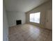 Living room with tile floors, fireplace, and large window at 4031 Tumble Wood Trl # 203, Tampa, FL 33613