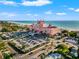 Picturesque aerial view of a large pink hotel near a sandy beach with ample parking at 407 41St Ave, St Pete Beach, FL 33706