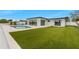 Backyard with artificial turf, pool, and modern white home at 407 41St Ave, St Pete Beach, FL 33706