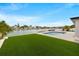 Waterfront backyard with artificial turf, pool, and views of the canal at 407 41St Ave, St Pete Beach, FL 33706