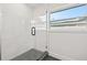 Modern shower with black and white tile and glass door by a window at 407 41St Ave, St Pete Beach, FL 33706
