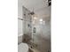 Bathroom featuring a glass-enclosed shower with gray subway tile and black hardware at 407 41St Ave, St Pete Beach, FL 33706
