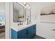 Stylish bathroom features double vanity with blue cabinets and modern black hardware at 407 41St Ave, St Pete Beach, FL 33706