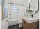 Bathroom with black hexagon tile, modern vanity and black hardware at 407 41St Ave, St Pete Beach, FL 33706
