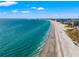 Expansive oceanfront view of the white sand beach and clear blue waters, perfect for a relaxing getaway at 407 41St Ave, St Pete Beach, FL 33706