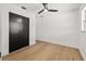 Bedroom with hardwood floors, closet with black sliding doors, and a window at 407 41St Ave, St Pete Beach, FL 33706