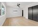 Bedroom with ceiling fan, hardwood flooring, neutral walls, and black closet doors at 407 41St Ave, St Pete Beach, FL 33706