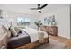 Bright bedroom boasts natural light, modern ceiling fan, wood floors, and view of water at 407 41St Ave, St Pete Beach, FL 33706