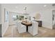 Bright dining area featuring hardwood floors, large windows, and stylish lighting at 407 41St Ave, St Pete Beach, FL 33706