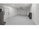 Garage with painted floor, new garage door hardware and white door to living space at 407 41St Ave, St Pete Beach, FL 33706