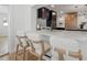 Modern kitchen featuring a quartz island with barstool seating and a black range hood at 407 41St Ave, St Pete Beach, FL 33706