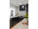 Modern kitchen featuring stainless steel appliances, custom range hood, sink with faucet, and center island with white countertops at 407 41St Ave, St Pete Beach, FL 33706