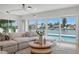 Living room featuring large windows with water views and comfortable modern decor at 407 41St Ave, St Pete Beach, FL 33706