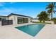 Inviting pool area with travertine tile, perfect for relaxation and entertaining, with lush tropical landscaping surrounding the home at 407 41St Ave, St Pete Beach, FL 33706