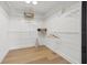 Walk-in closet offers white wire shelving and hardwood flooring at 407 41St Ave, St Pete Beach, FL 33706