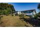 Home's backyard with grass and mature trees at 4573 Deltona Blvd, Spring Hill, FL 34606