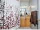 Bathroom with a floral shower curtain and light wood vanity at 4573 Deltona Blvd, Spring Hill, FL 34606