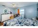 Bedroom with white dresser, ceiling fan, and orange curtains at 4573 Deltona Blvd, Spring Hill, FL 34606