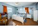 Main bedroom with a white bed frame and orange curtains at 4573 Deltona Blvd, Spring Hill, FL 34606