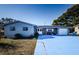 Ranch style home with brick entryway, attached garage, and large driveway at 4573 Deltona Blvd, Spring Hill, FL 34606