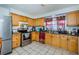 Kitchen with light wood cabinets, stainless steel appliances, and tile floor at 4573 Deltona Blvd, Spring Hill, FL 34606