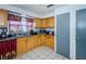 Galley kitchen with wood cabinets and ample counter space at 4573 Deltona Blvd, Spring Hill, FL 34606