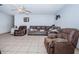 Cozy living room featuring brown leather furniture and tile floors at 4573 Deltona Blvd, Spring Hill, FL 34606