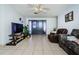 Spacious living room with tiled floors and comfy seating at 4573 Deltona Blvd, Spring Hill, FL 34606