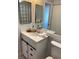 Modern bathroom with updated vanity and a large mirror at 4823 Ebbtide Ln # 405, Port Richey, FL 34668