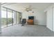 Spacious living room with balcony access and relaxing seating area at 4823 Ebbtide Ln # 405, Port Richey, FL 34668