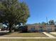 House with tree, flagpole, and large yard at 4825 Sierra Madre Dr, Tampa, FL 33634