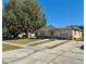 Ranch style home with mature landscaping and a spacious driveway at 4825 Sierra Madre Dr, Tampa, FL 33634