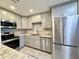 Modern kitchen with stainless steel appliances and granite countertops at 4825 Sierra Madre Dr, Tampa, FL 33634