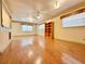 Large living area with hardwood floors and built-in shelving at 4825 Sierra Madre Dr, Tampa, FL 33634