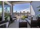 Relaxing balcony with water views and wicker furniture at 507 Tamiami N Trl # 201, Venice, FL 34285
